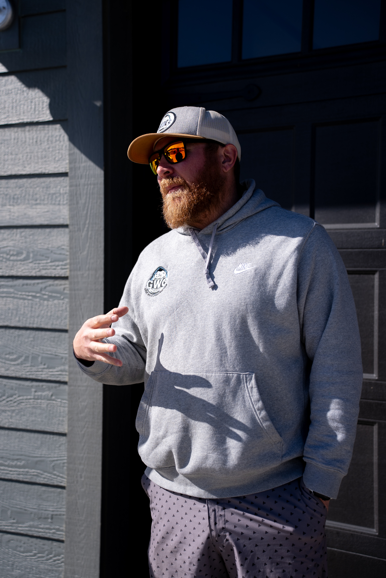Great White Construction team member speaking with a homeowner outside a residence